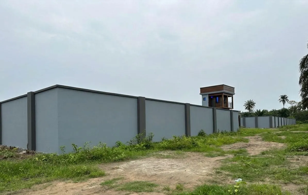 ECO SAVANA perimeter wall painted and standing on site at Omagwa, with the completed security tower behind it